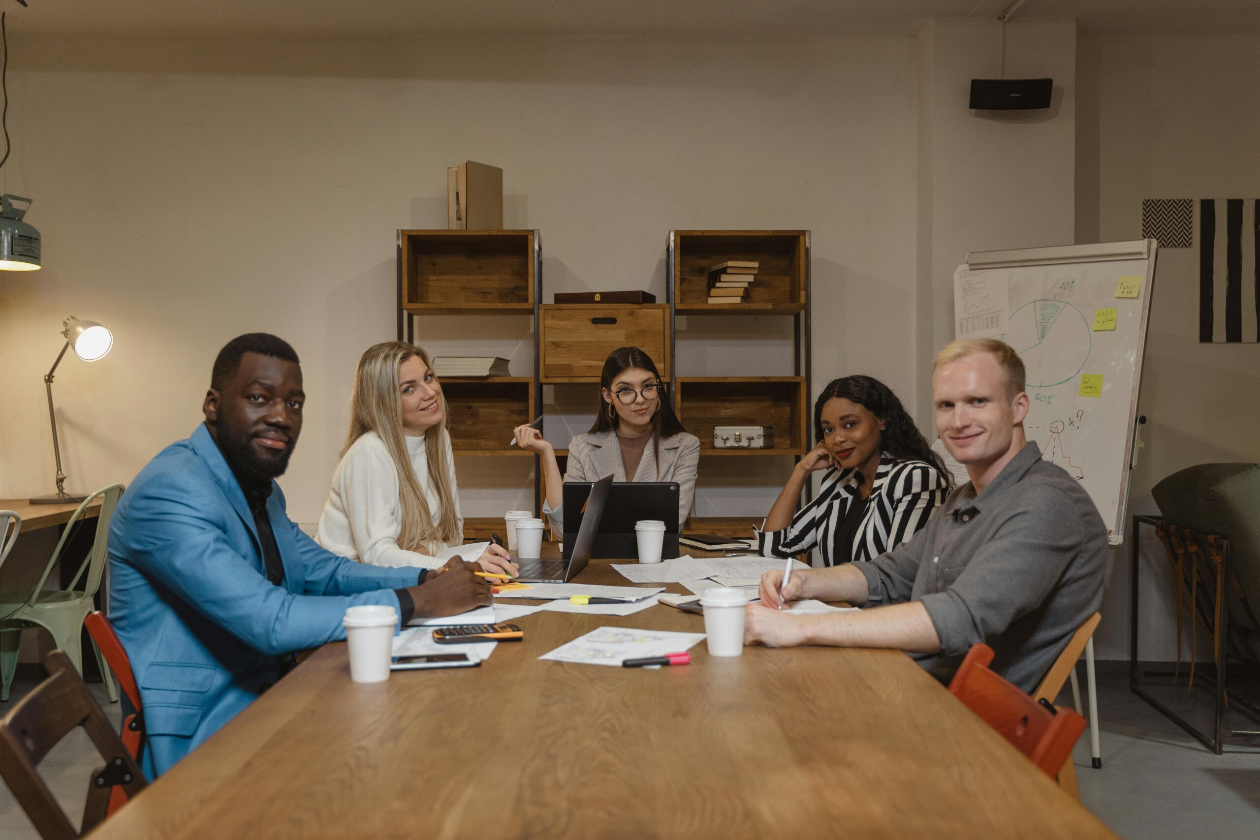 People sitting at a wooden table.